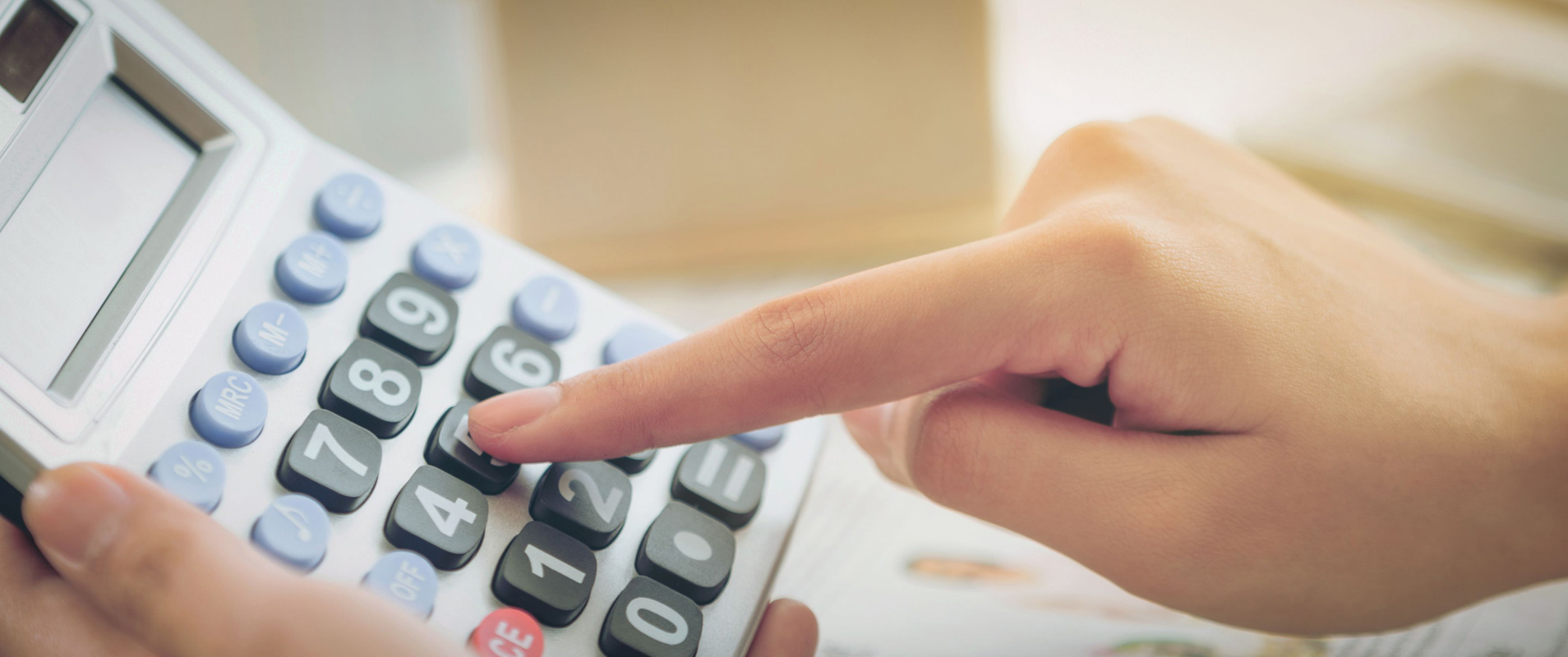 Woman accountant or bank worker uses calculator.